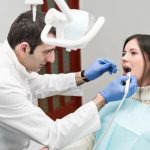 dentist performing painless root canal treatment on a patient
