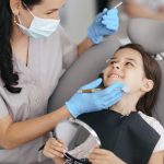 child receiving a dental checkup to help prevent tooth decay and cavities
